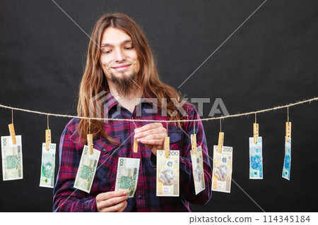 Rich man with laundry of money 114345184