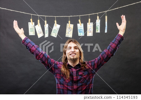Rich man with laundry of money 114345193
