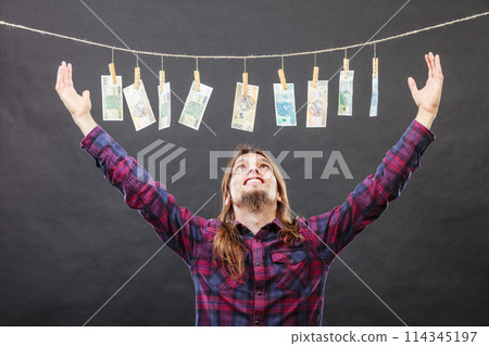 Rich man with laundry of money 114345197