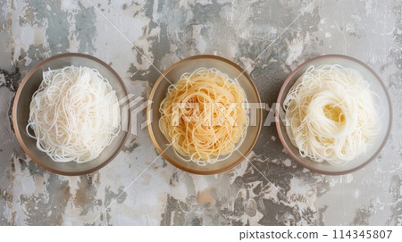 Shirataki noodles in bowl on concrete background, top view Shirataki noodles in bowl on concrete background, top view 114345807