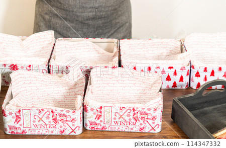 Lovingly homemade gingerbread and sugar cookies, half-dipped in rich chocolate, nestled in decorative Christmas tin boxes perfect for seasonal gifting. 114347332
