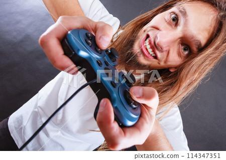 Happy man playing games Happy man playing games 114347351