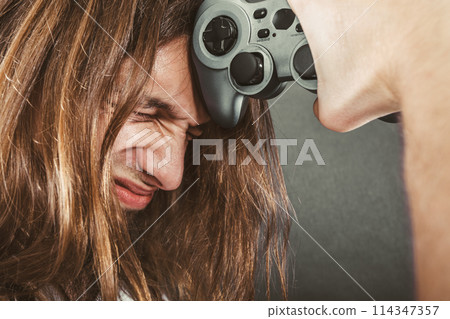 Unhappy male playing games 114347357