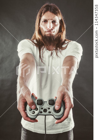 Male player focus on play games 114347358