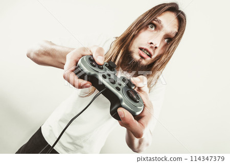 Unhappy male playing games Unhappy male playing games 114347379