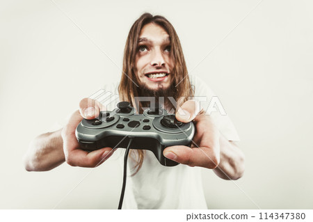 Stressed man playing on pad Stressed man playing on pad 114347380