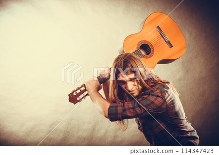 Rock musician destroys his guitar. Rock musician destroys his guitar. 114347423