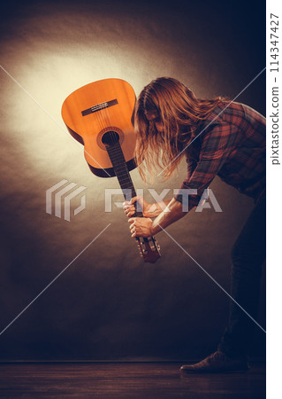 Rock musician destroys his guitar. Rock musician destroys his guitar. 114347427