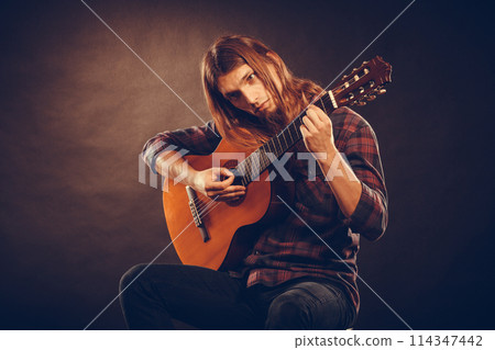 Guitarist trying out chords. Guitarist trying out chords. 114347442