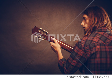 Rear view of young musican. Rear view of young musican. 114347444