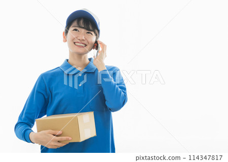 A female delivery person talking on her smartphone (delivery, light cargo driver, delivery, delivery person, courier service) 114347817