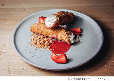 Gourmet Dessert Plate With Cannoli, Fresh Strawberries, and Crumbled Topping Gourmet Dessert Plate With Cannoli, Fresh Strawberries, and Crumbled Topping 114347848