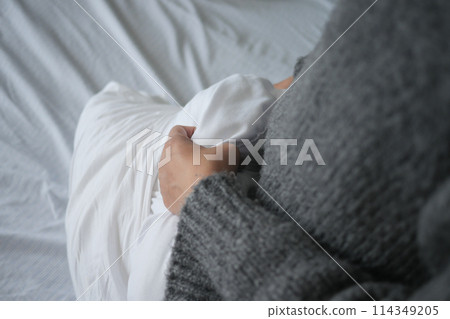 Woman Puts Pillow Into Pillowcase. 114349205