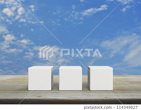 Three white block cubes on wooden table Three white block cubes on wooden table 114349827