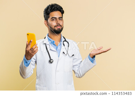 Doctor man using smartphone show point empty place, advertising application area, positive feedback Doctor man using smartphone show point empty place, advertising application area, positive feedback 114353483