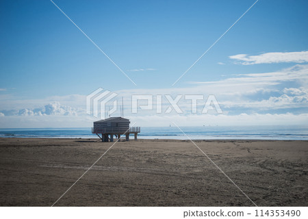 Gruissan - France - 27 April 2024 - view of wooden life guard station on the beach on beautiful cloudy sky background 114353490