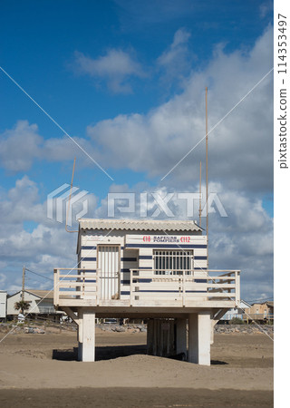 Gruissan - France - 27 April 2024 - view of wooden life guard station on the beach on beautiful cloudy sky background 114353497