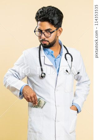 Doctor man receive bribe from patient, taking money from client, hiding cash into pocket, corruption 114353535
