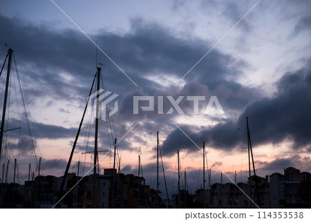 view of sailboats silhouettes in the harbor on sunset background view of sailboats silhouettes in the harbor on sunset background 114353538