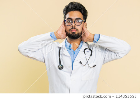 Annoyed irritated doctor man covering ears gesturing no avoiding advice ignoring noise loud voices Annoyed irritated doctor man covering ears gesturing no avoiding advice ignoring noise loud voices 114353555