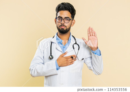 Doctor man raising hand to take oath, promising to be honest and to tell truth keeping hand on chest Doctor man raising hand to take oath, promising to be honest and to tell truth keeping hand on chest 114353556