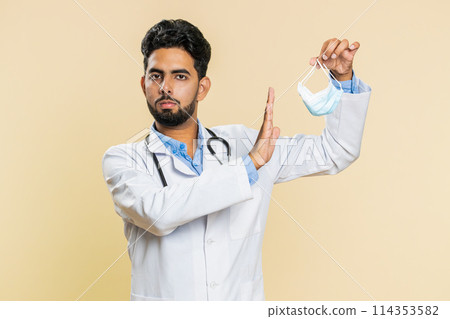 Happy Indian doctor man removing, taking off medical protective mask, ending of flu pandemic 114353582
