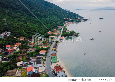 Costal village in Florianopolis, Brazil. Coastline with mountains and buildings 114353742