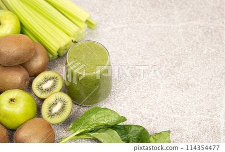 Green smoothie with kiwi, apples, celery, spinach, a healthy natural foods dish, copy space for text Green smoothie with kiwi, apples, celery, spinach, a healthy natural foods dish, copy space for text 114354477