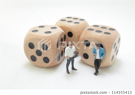 a Businessman reading book with dice. Education and business Concept. a Businessman reading book with dice. Education and business Concept. 114355413