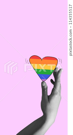 Hand gently holding vibrant rainbow heart, representing the LGBTQ community against pink background. Contemporary art collage. 114355517