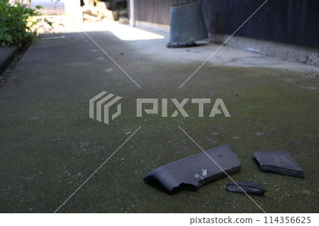 A roof tile from a house that fell due to the earthquake A roof tile from a house that fell due to the earthquake 114356625