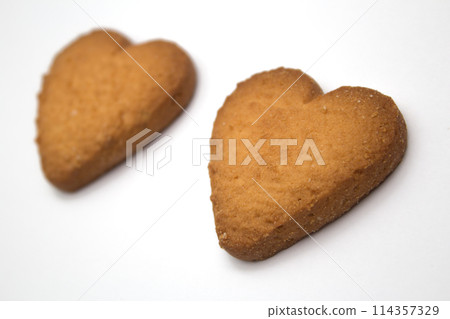 Two cookies in the form of hearts - symbol of love Two cookies in the form of hearts - symbol of love 114357329