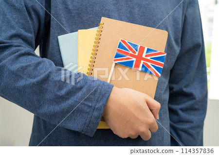 Learn English language, Asian teenage student hold book with flag in course at school. 114357836