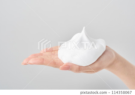 A woman's hand placing a small ball of foam on her palm A woman's hand placing a small ball of foam on her palm 114358067