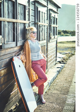 Young mature blonde woman outdoor with a bodyboard. 114358739