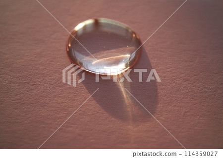 Beautiful volumetric drop of cosmetic product on a pink background. 114359027