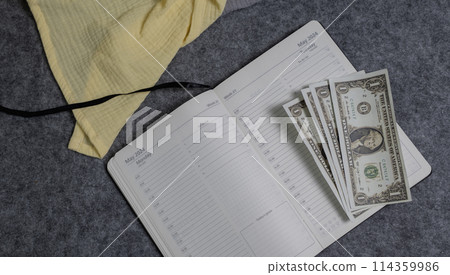 notebook with a blank sheet and paper money 114359986
