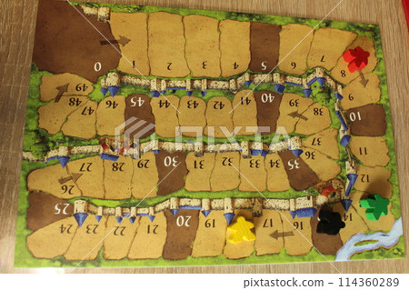 Mozyr, Belarus, April 03 2024: Tablet for calculating the progress of players in the board family game Carcassonne. Red Yellow Melinated Black Meeple on Tablet. Gameplay 114360289