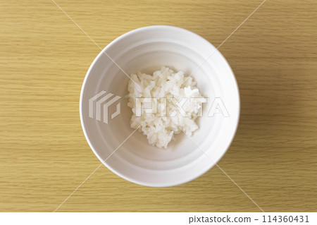 A little bit of rice in a bowl. An image of poverty. 114360431