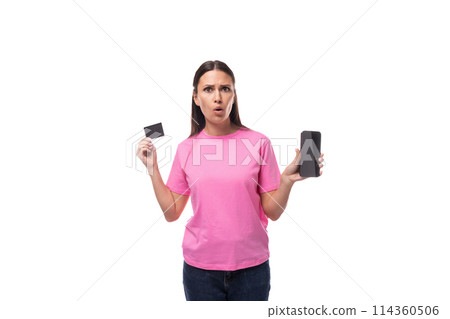 young stylish woman with straight black hair dressed in a pink t-shirt holding a credit card and a 114360506