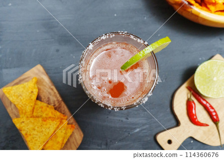 Mexican cocktail, michelada, made with beer and tomato juice. Selective focus Mexican cocktail, michelada, made with beer and tomato juice. Selective focus 114360676