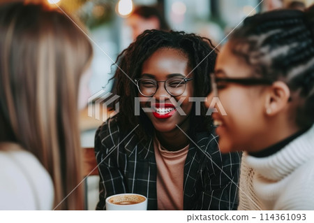 a cheerful group of friends sitting at a table talking in a cafe a cheerful group of friends sitting at a table talking in a cafe 114361093