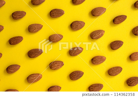 pattern of peeled almond on yellow background 114362358
