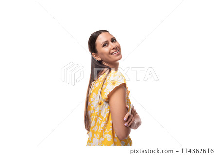 caucasian pleasant cute young woman with straight black hair dressed in a yellow sundress 114362616