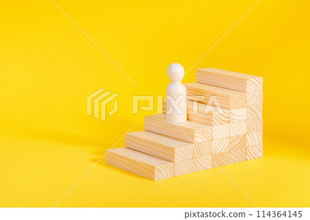Businessman climbing stairs. Business success process, career ladder. Wooden figurine 114364145