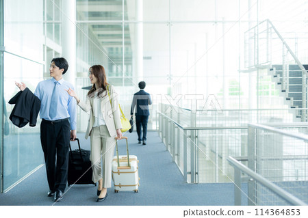 A businessman walking in the airport A businessman walking in the airport 114364853