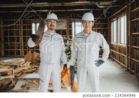 Workers working at a demolition site 114364946