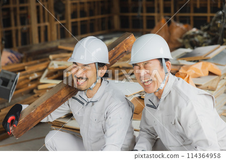 Workers working at a demolition site 114364958