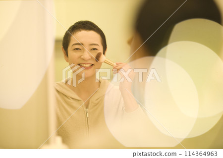 Middle-aged woman doing night skin care Middle-aged woman doing night skin care 114364963