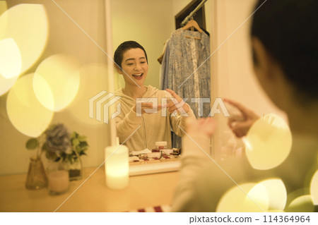 Middle-aged woman doing night skin care Middle-aged woman doing night skin care 114364964